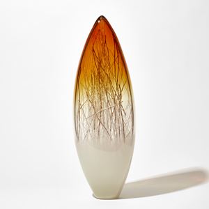 tall pointed oval sculpture with light cream base clear middle and bright amber gold top containing thin strands in white and gold hand made from glass