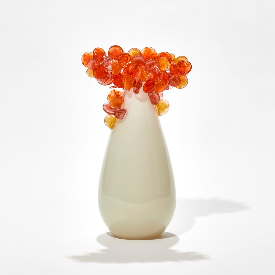 simple tree form hand made from glass with alabaster and cream coloured teardrop shaped trunk with bright orange and gold clustered lollipop leaves on top