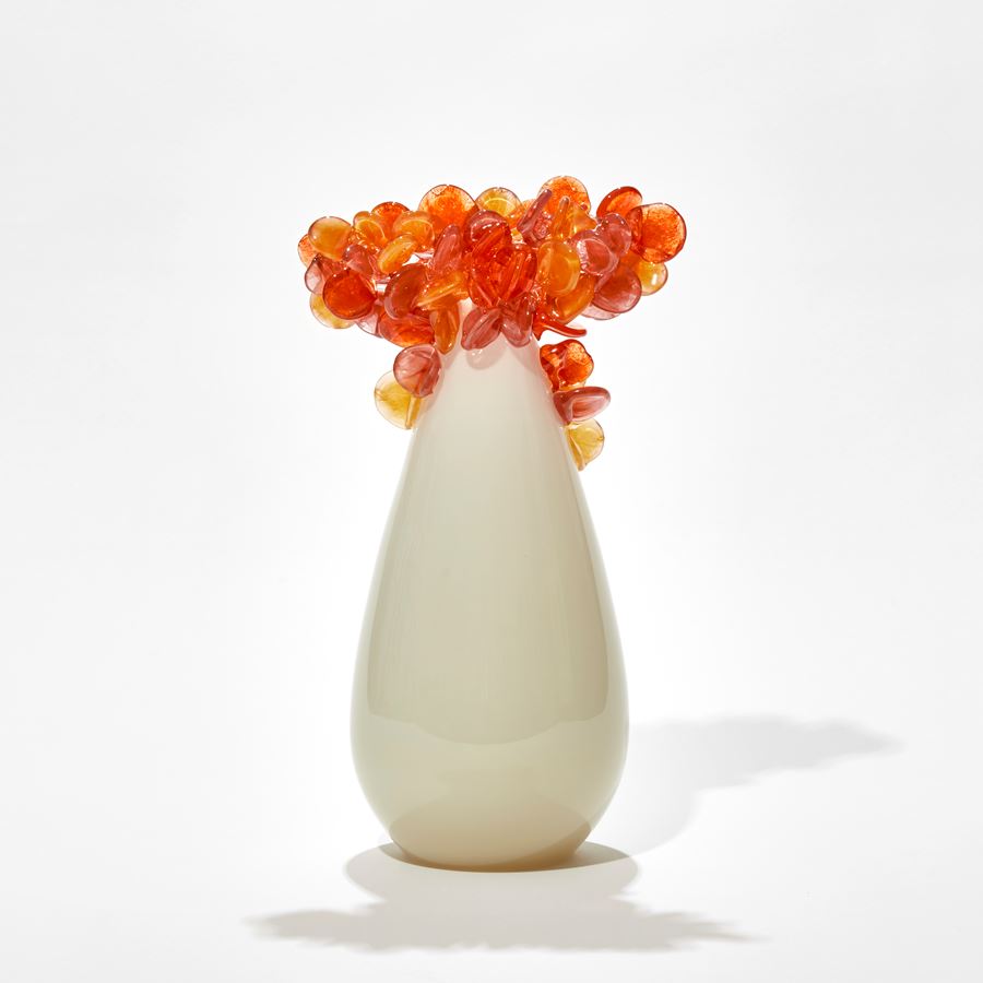 simple tree form hand made from glass with alabaster and cream coloured teardrop shaped trunk with bright orange and gold clustered lollipop leaves on top