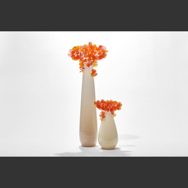 tall cream beige and orange simplified tree sculpture with a smooth column trunk and cluster of lollipop like leaves covering the top