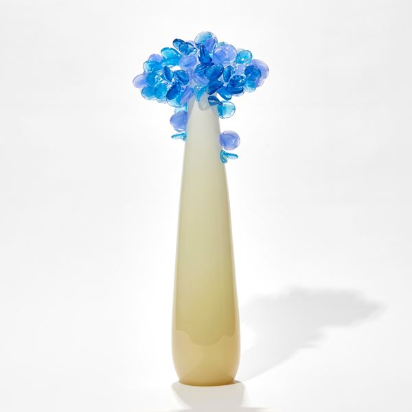 tall pop art hand made glass tree with alabaster coloured smooth trunk and candy coloured blue rounded mass of leaves on top