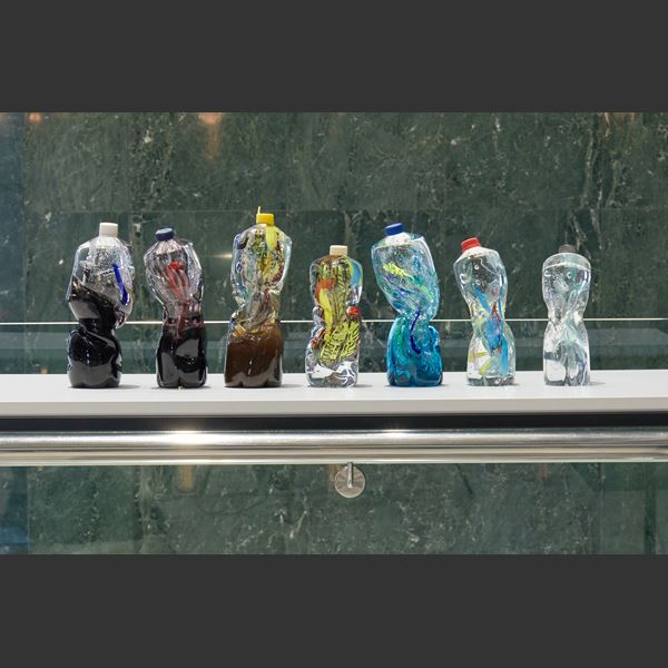 art-glass sculpture of crumpled wasted plastic bottles 
