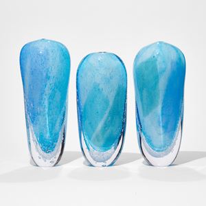 aqua light blue and clear tall soft forms based on icebergs with clear bottom lined with bubbles hand made from glass