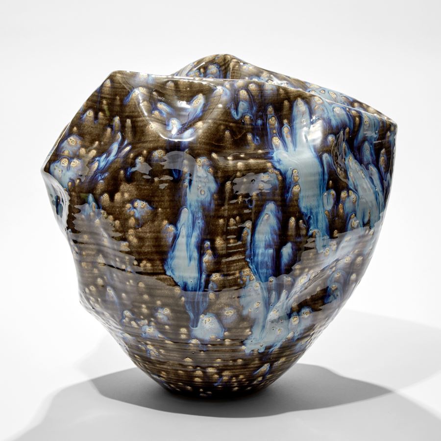crumpled formed vessel with blue grey and white speckled smeared and running glaze hand made from ceramic