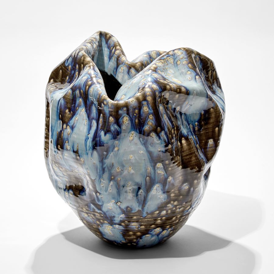 crumpled formed vessel with blue grey and white speckled smeared and running glaze hand made from ceramic