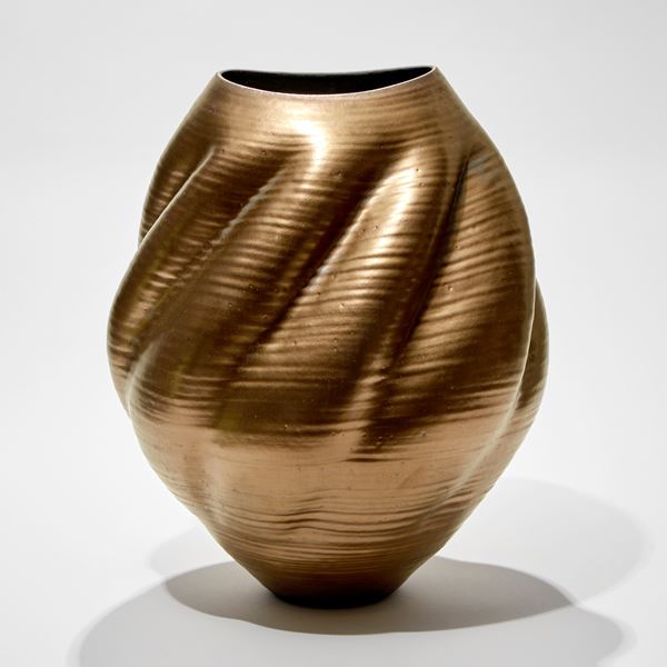 gold shell like vessel with twisting form and spiralling ridges hand made from glass