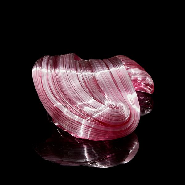 pink arched and bending ridged candy cane sculpture hand made from glass