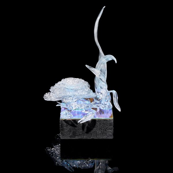 low square base with still life composition on top including a crab coral reef stack and tall marine plant life hand made from clear glass