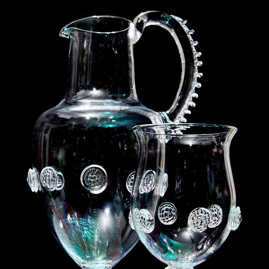 three dimensional still life setting with pitcher goblet corn heads hand made from glass