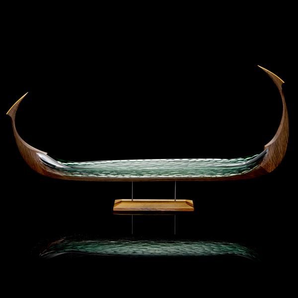 long viking ship with oak hull and soft green blown and cut hull handmade and raised on a stand
