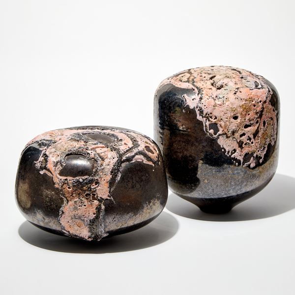 round low solid mushroom form sculpture with metallic bronze finish and relief lava like detail pink hand made from glass