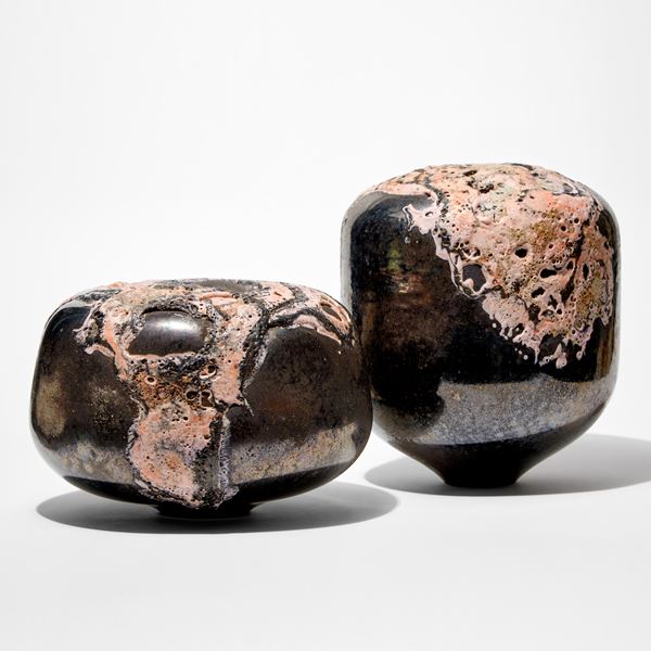 round low solid mushroom form sculpture with metallic bronze finish and relief lava like detail pink hand made from glass