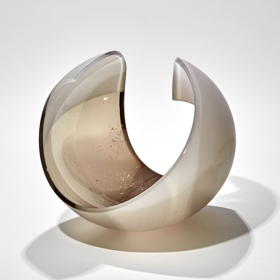 curled shell like form in bronze and pink with a shower of tiny golden dots handmade from glass