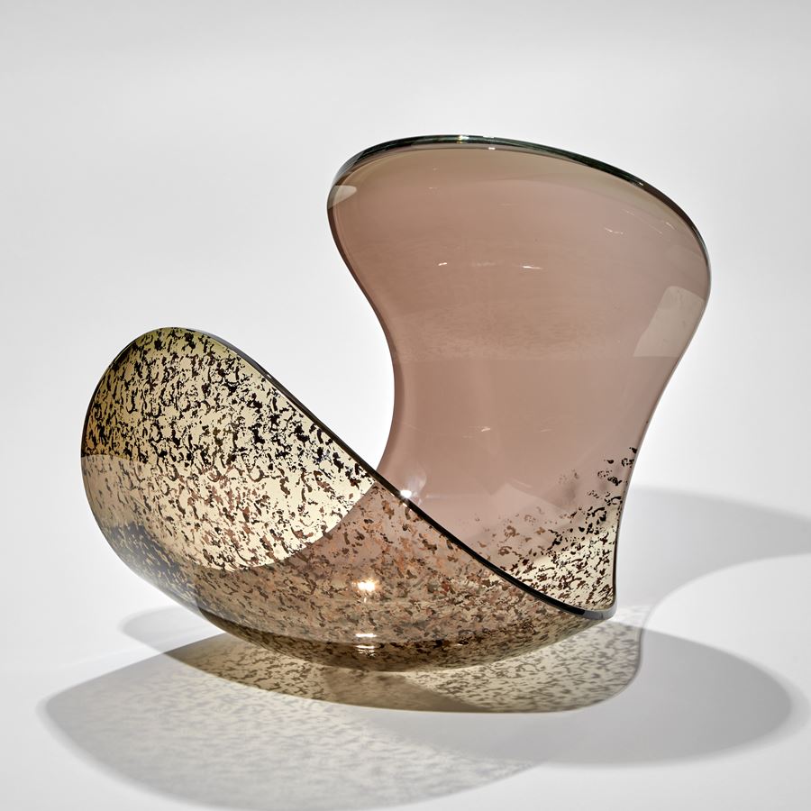 rounded form with dramatic curved edge and dropped side in ducky pink and bronze with gold speckled detail handmade from glass