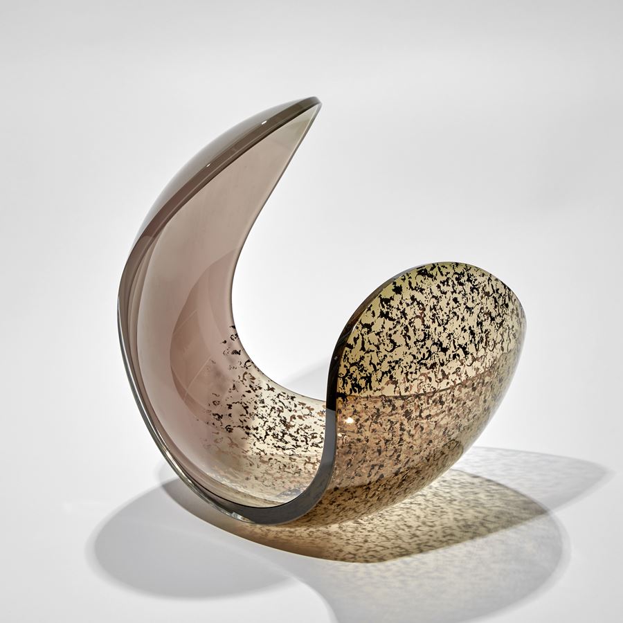 rounded form with dramatic curved edge and dropped side in ducky pink and bronze with gold speckled detail handmade from glass