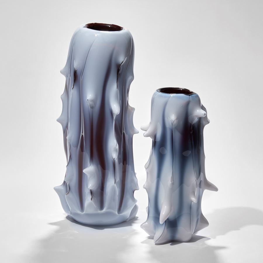 tall white abstract glass sculptre with random protruding scale-like edges and black shading
