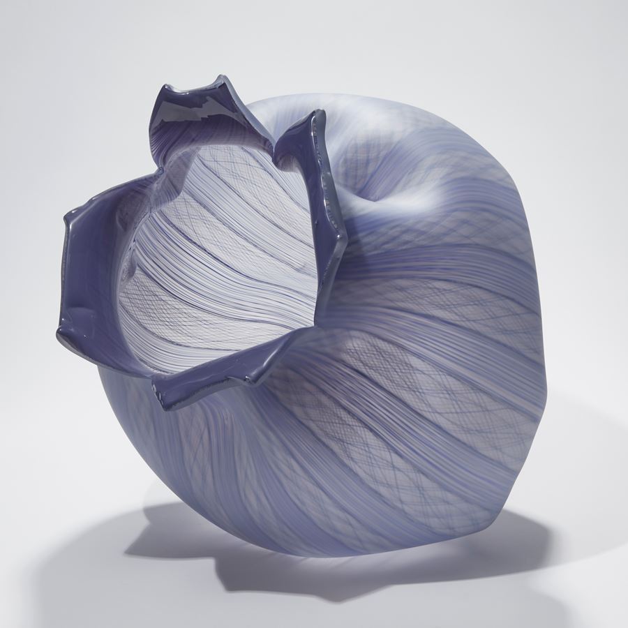 purple and lilac glass sculpture of open fruit with lined pattern