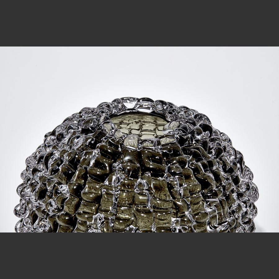 urchin inspired round handmade glass sculpture in bronze grey colour with undulating ridged surface