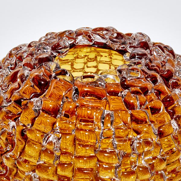 urchin inspired amber gold round sculpture with undulating surface handmade from glass