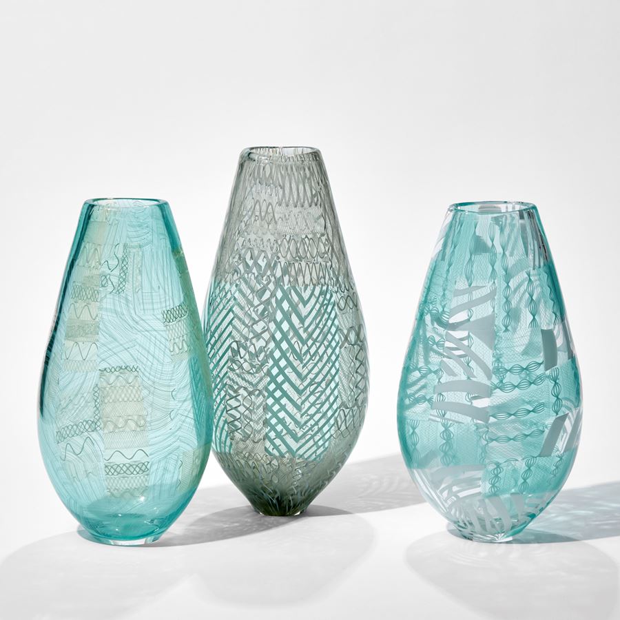 art glass vase in turquoise and white with modern line patterns