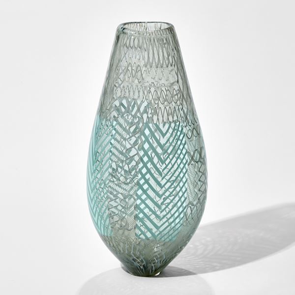 art glass vase in light green and grey with various external lined patterns