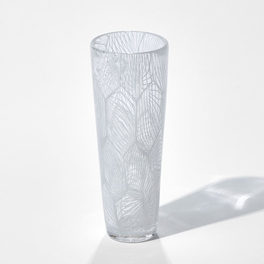 tall clear glass sculpture with external white pattern