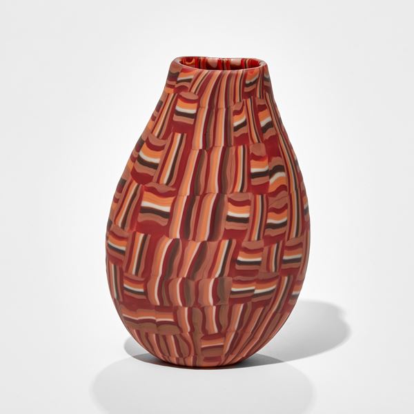 teardrop shaped vase with abstract mosaic block pattern in red orange black and white hand made from glass