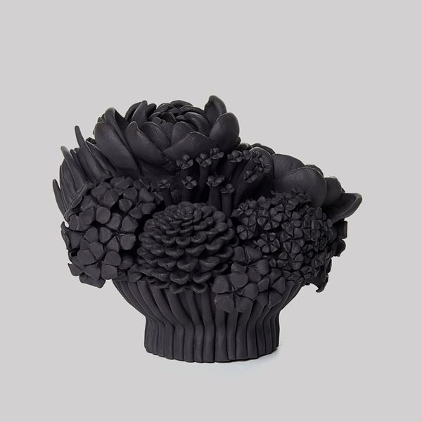 black stoneware sculpted artwork of mixed flowers