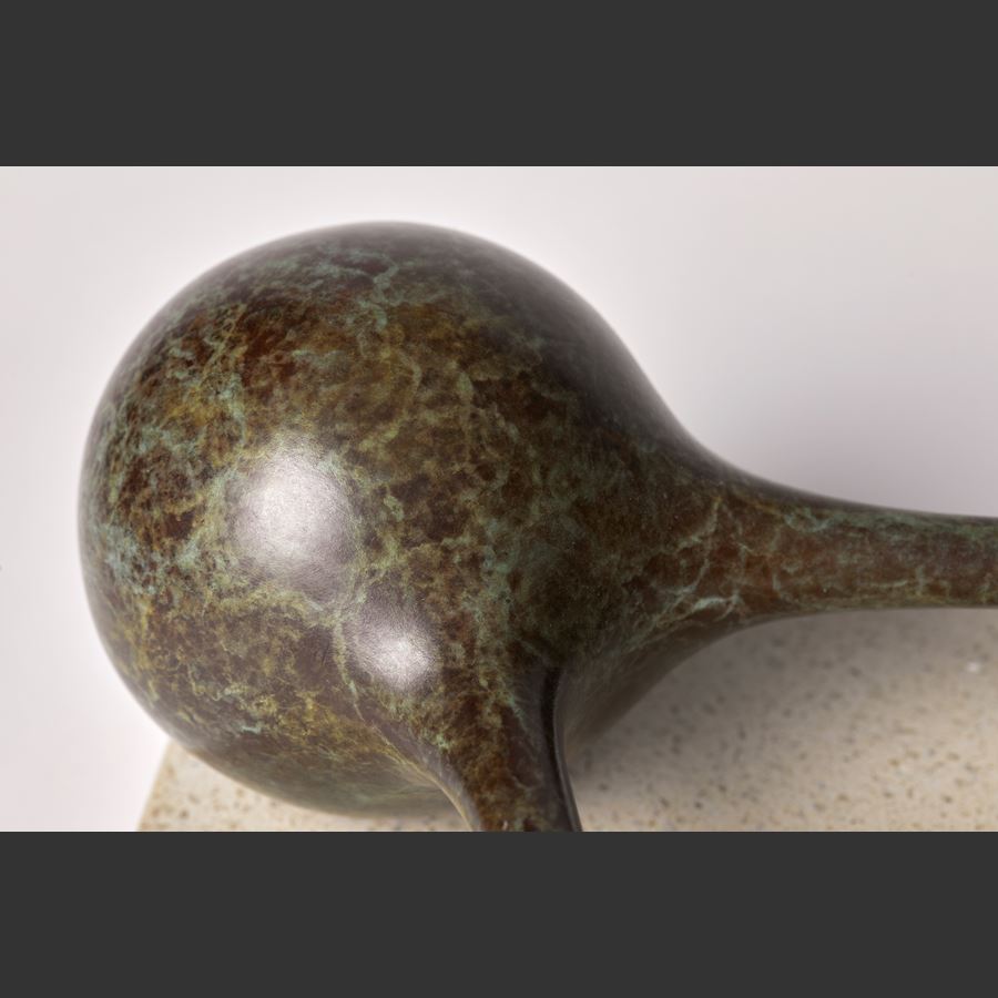 bronze minimalist sculpture of connected spheres on limestone base