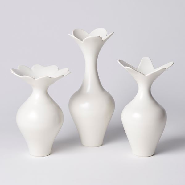 tall white vase with bulbous middle long neck and five scalloped flared rim hand made from porcelain
