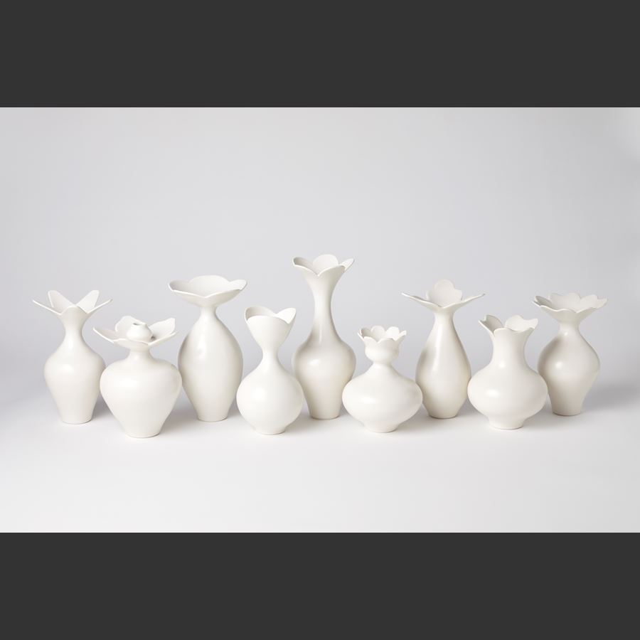 white squat rounded vase with flower shaped opening with eight petals hand made from porcelain