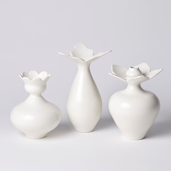 teardrop shaped white vase with wide opening made up from three extending flat pointed petals hand made from porcelain