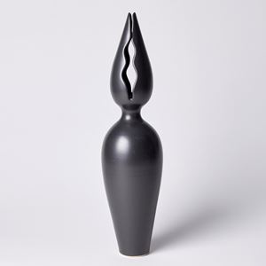 tall black porcelain sculpture with classical vase and pointed flower bud top with narrow wavy openings