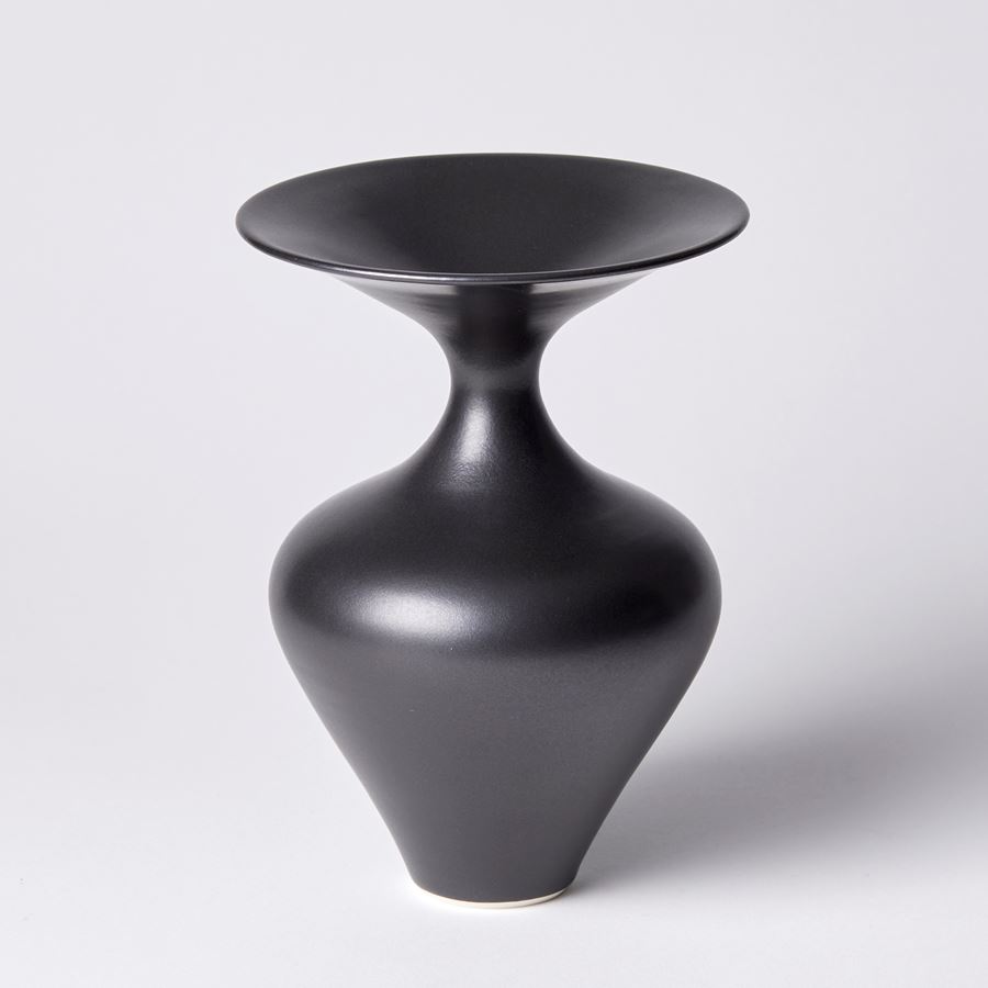 rounded black vase with wide flared rim and narrow neck hand made from porcelain