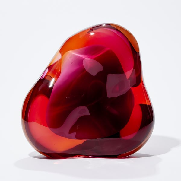 amorphic abstract form consisting of merging pink and amber covering an inner of crisp white handmade from glass with central cavity
