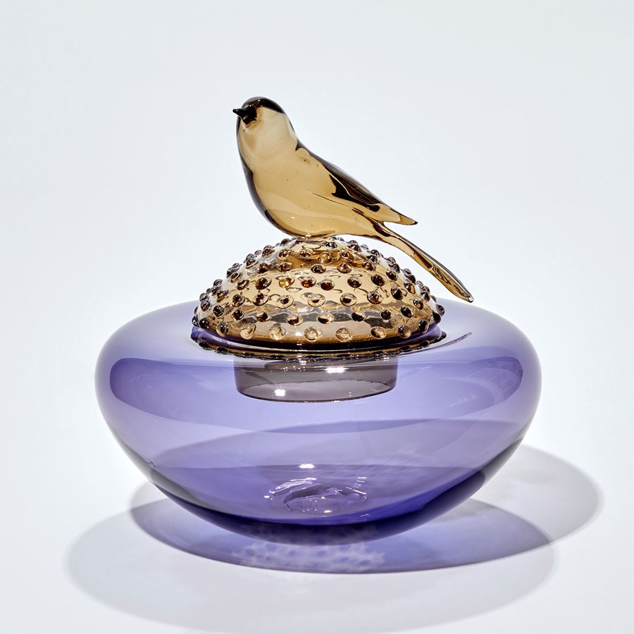 purple and bronze low centrepiece with lid covered in raised dots and perched bronze bird hand made from glass