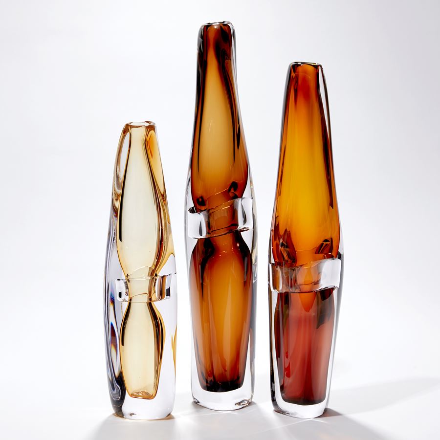 tall transparent warm brown vase with organic lines and central clear band handblown from glass