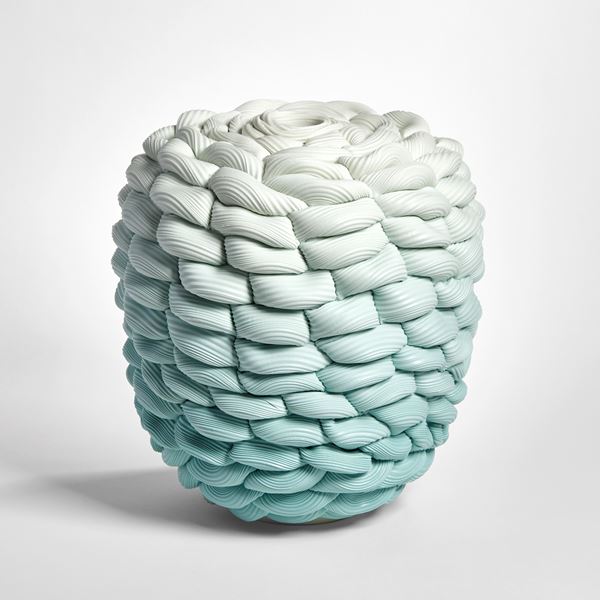 teal aqua fading to off white chunky woven and ridged vessel in a flat topped barrel shape hand made from parian porcelain
