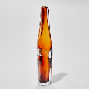 tall soft and undulating rich amber and clear vase hand made from glass