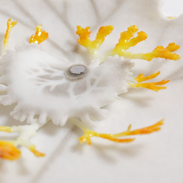 white grey and amber yellow round disc with organic lichen and fern shaped  protruding detail handmade in glass