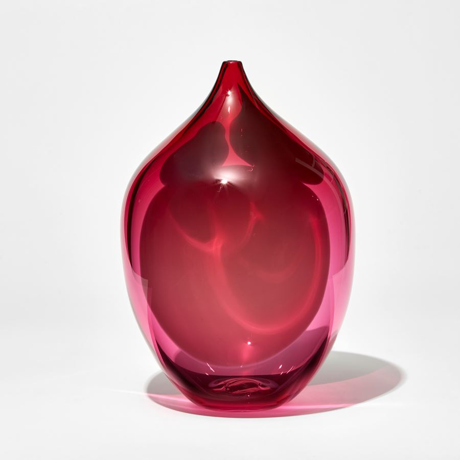 transparent rich ruby pink rounded jar with narrow neck with small opening with abstract amorphous blobs in opaque baby pink blue and soft pink hand made from glass