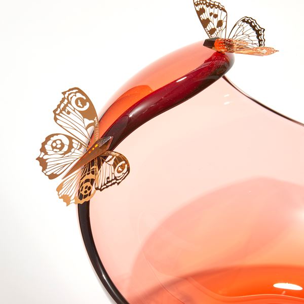 low round peach centrepiece with curved sweeping dropping rim with three gold butterflies perched on the edge hand made from glass steel and gold