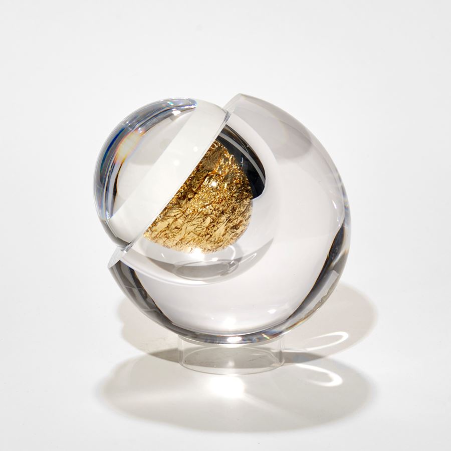 clear round glass orb with hollow interior filled with crushed gold leaf hand made glass