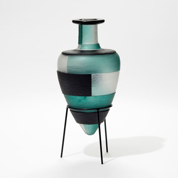 jade clear and dark forest green amphora glass bottles with textured surface and block pattern perched in a tripod black steel base