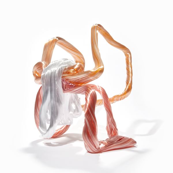 twisted looping candy cane standing angular structure constructed from ridged canes in white pink and coral orange hand made from glass