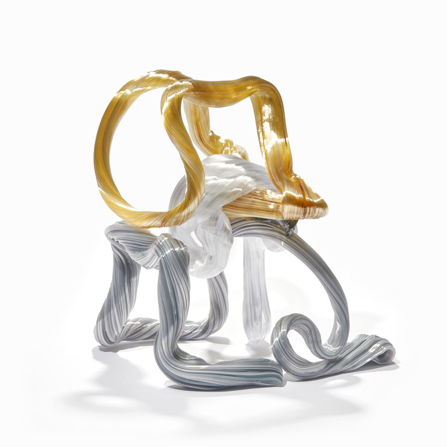 looped ridged candy canes in white amber and grey creating a standing form handmade from glass