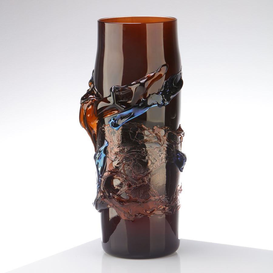 rich dark transparent amber brown vase with tapering neck with raised organic textured detail in metallic blue and brown handblown from glass