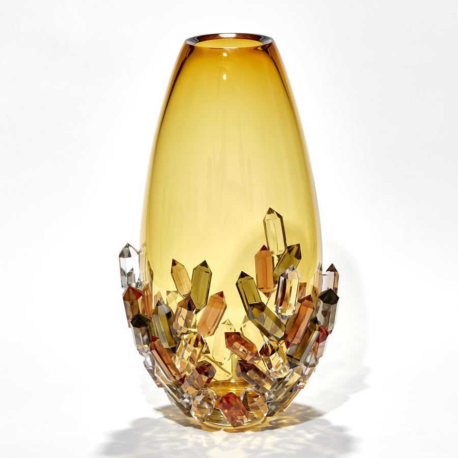 transparent golden amber teardrop shaped vase with the lower half covered in crystals each in a single colour of bronze amber peach sepia and olive green hand made from glass