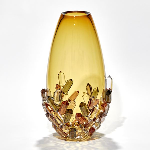 transparent golden amber teardrop shaped vase with the lower half covered in crystals each in a single colour of bronze amber peach sepia and olive green hand made from glass