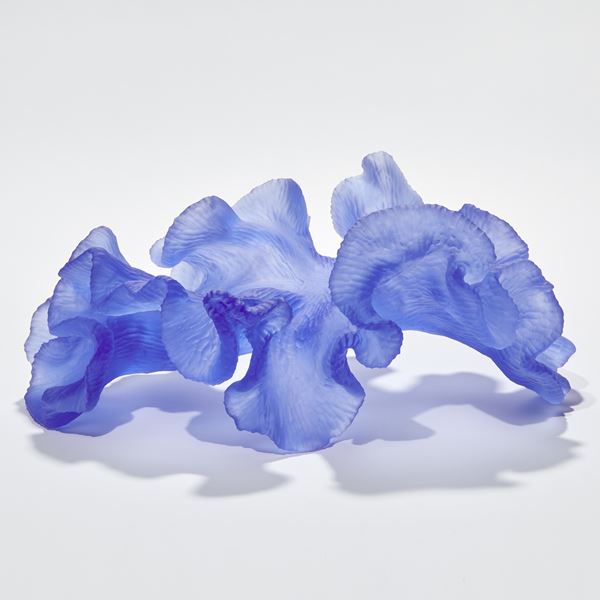rich royal blue abstract sculpture with textured surface with the appearance of coral with frilled edges hand made from glass